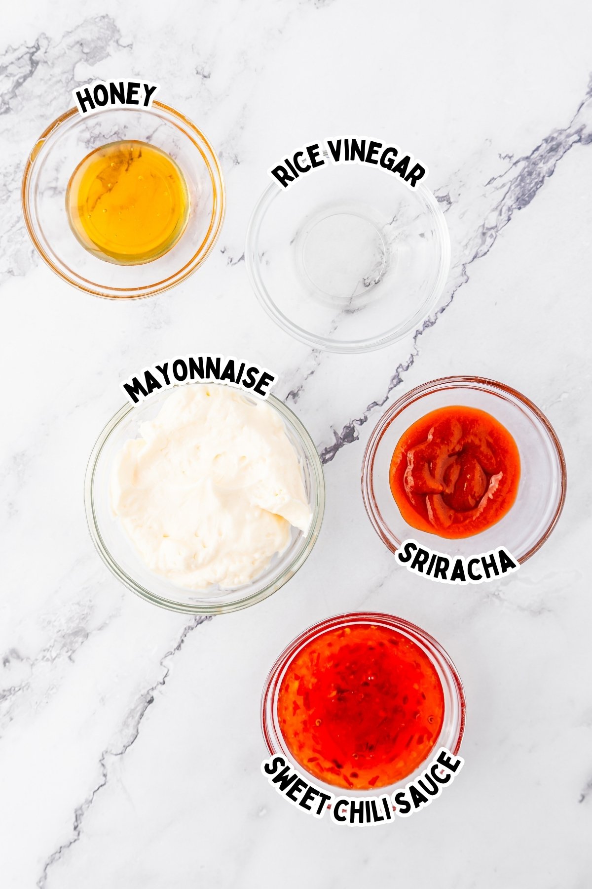 Five labeled bowls with honey, rice vinegar, mayonnaise, sriracha, and sweet chili sauce.