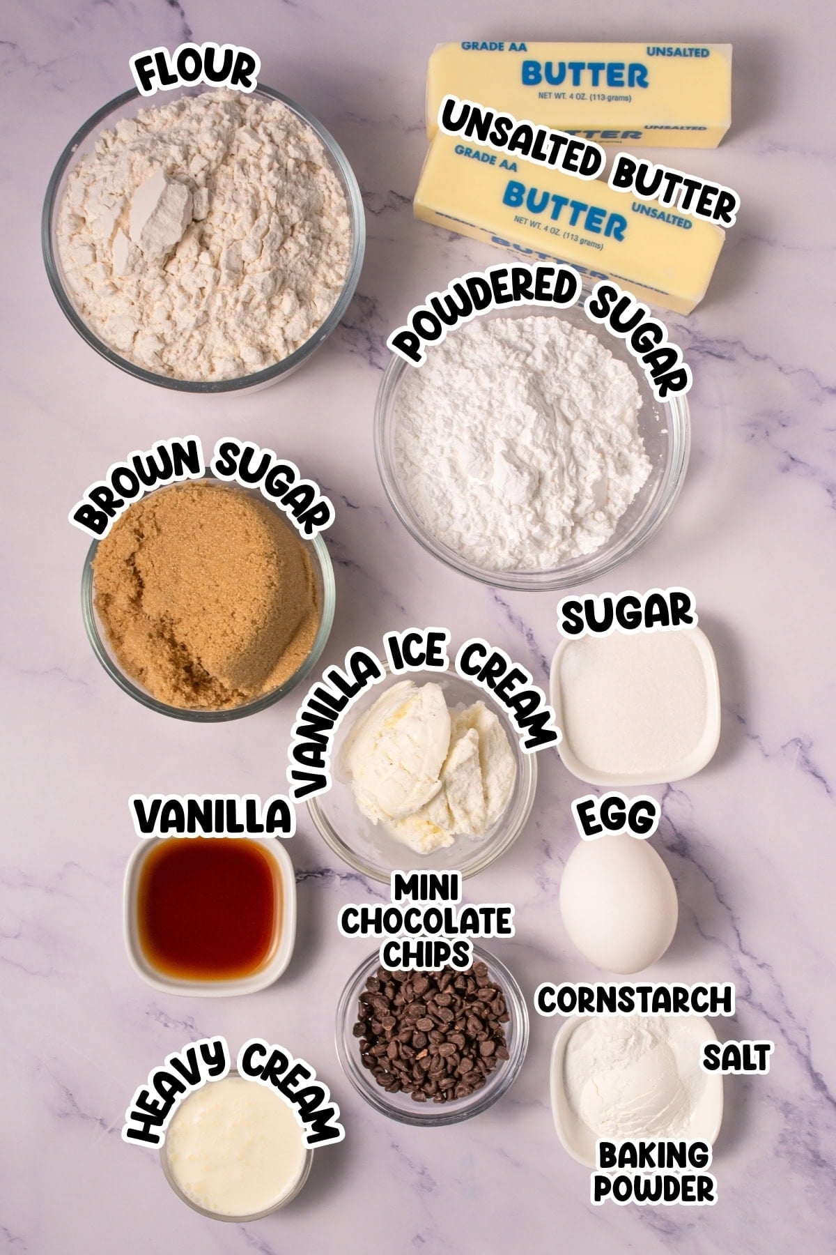 Baking ingredients in bowls labeled: flour, sugars, butter, egg, cream, and more.