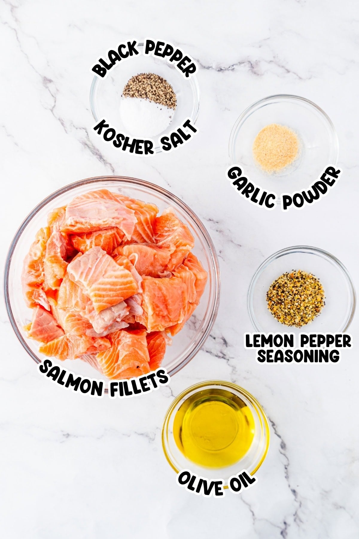 Raw salmon fillets with olive oil, black pepper, salt, garlic powder, and seasoning.