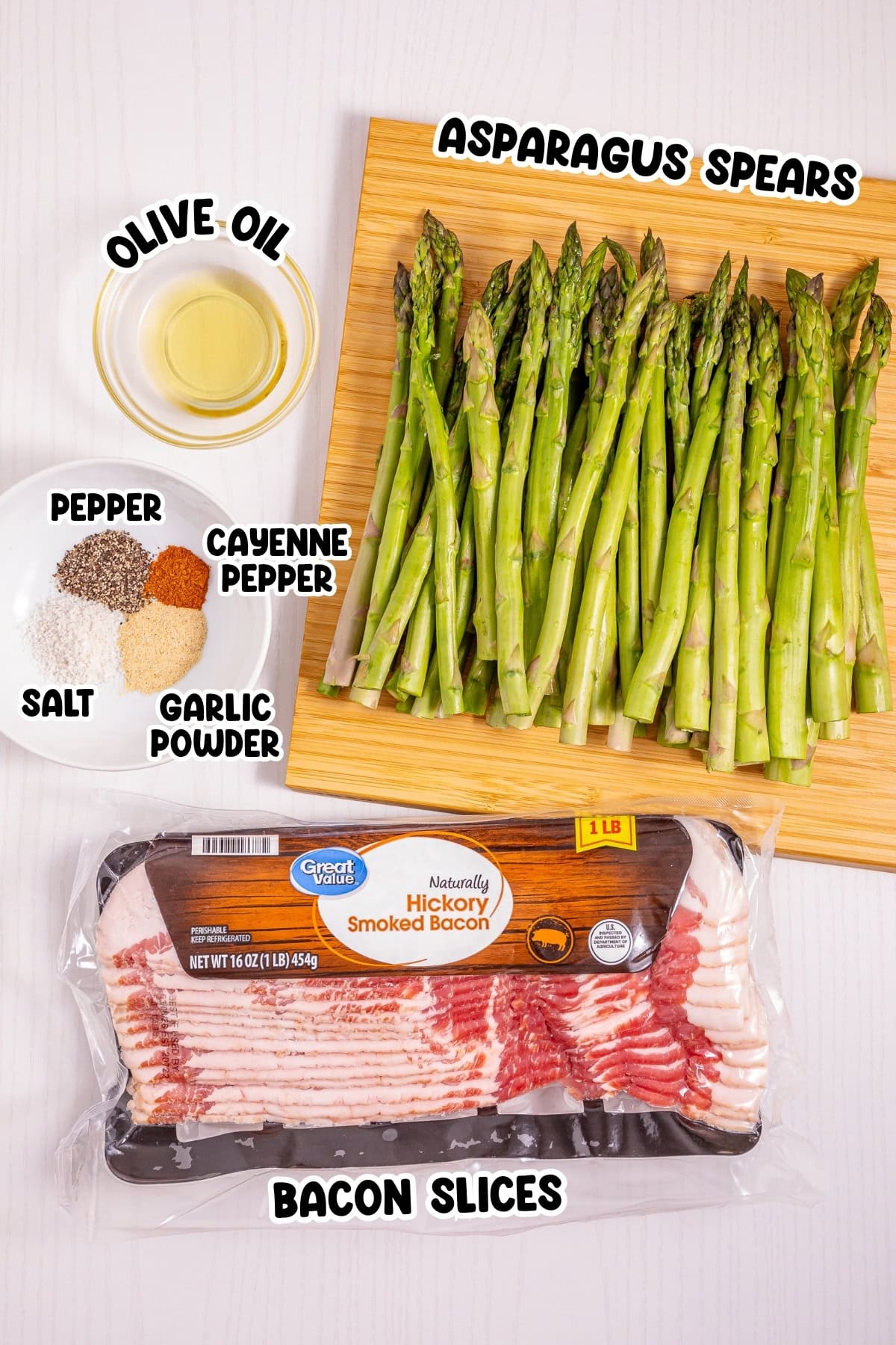 Asparagus, spices, olive oil, and bacon slices arranged on a white surface.
