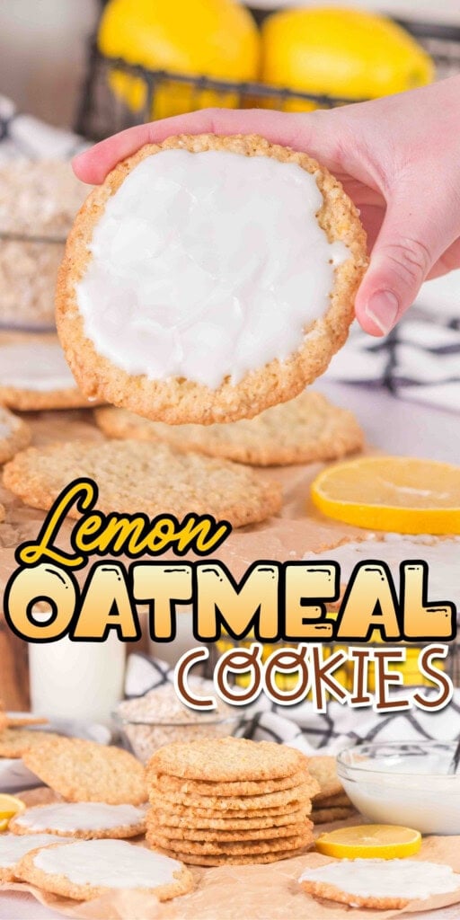 A hand holds a glazed oatmeal cookie, with lemons and more cookies in the background.