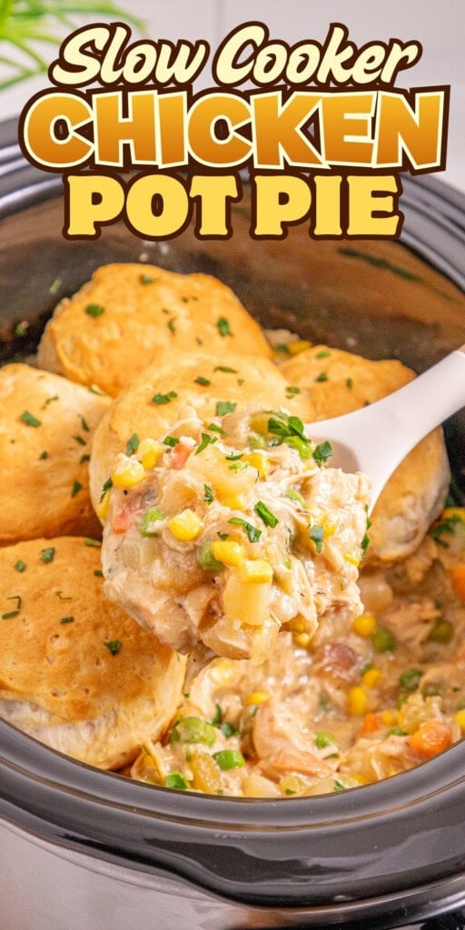 A spoon scoops chicken pot pie filling from a slow cooker topped with biscuits.