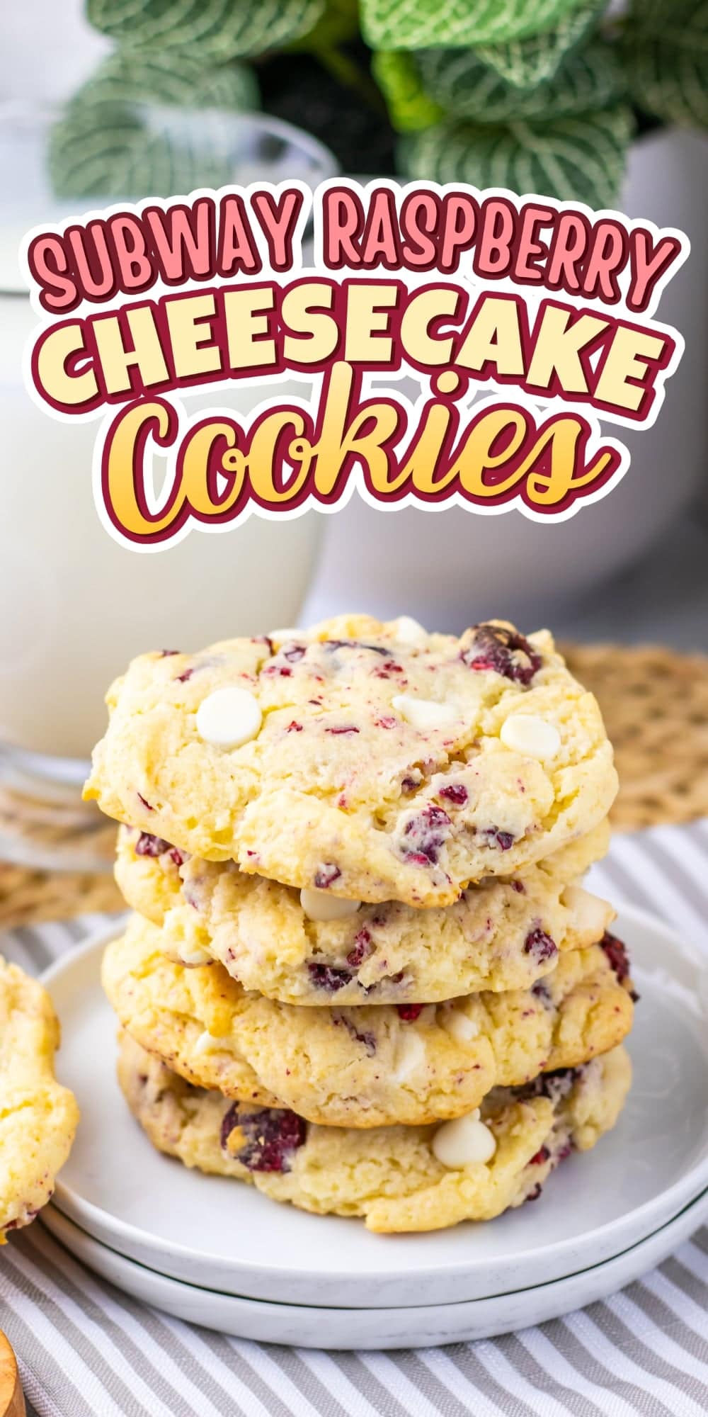 A stack of raspberry cheesecake cookies next to a glass of milk.
