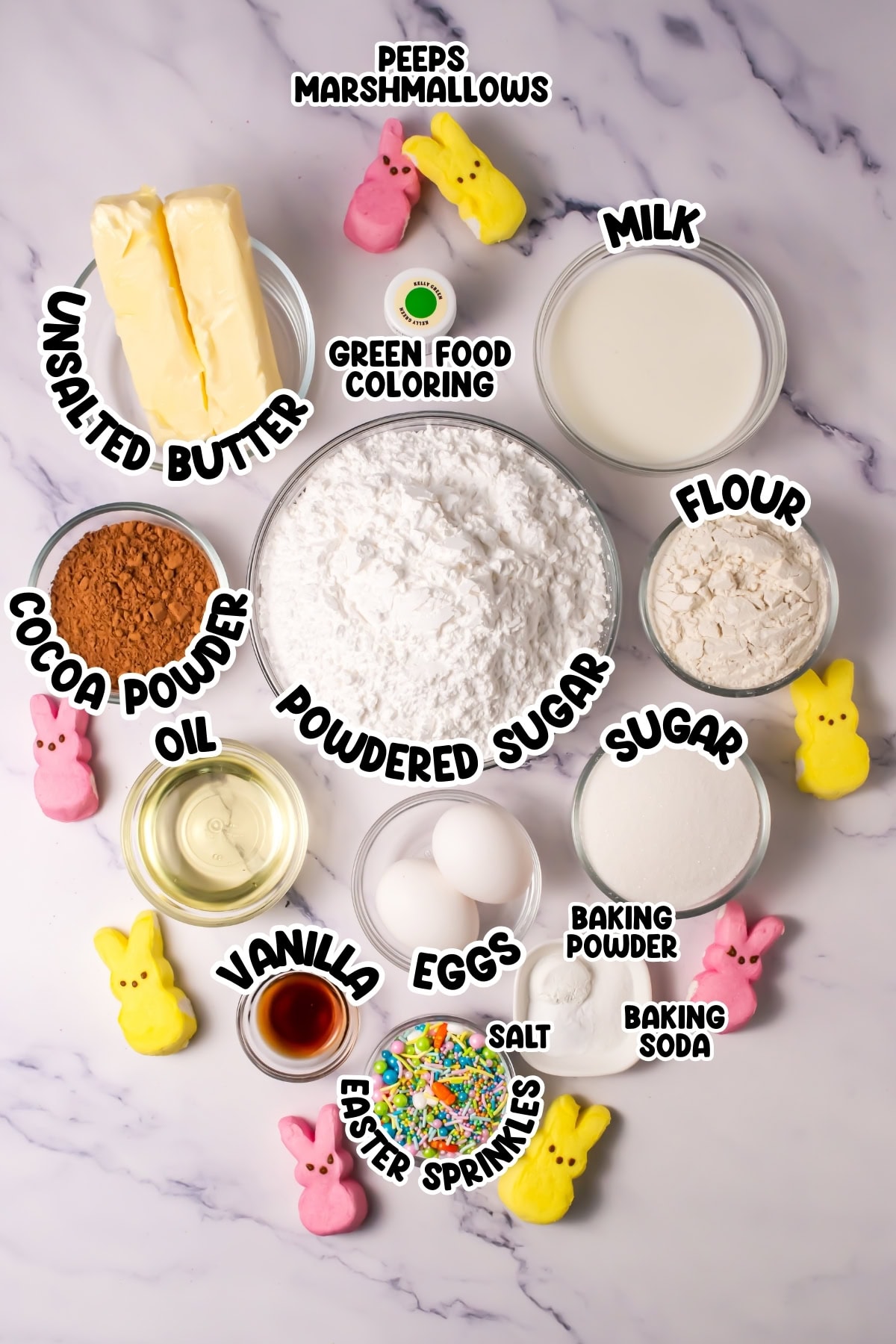 Baking ingredients and Peeps marshmallows arranged on a marble background.