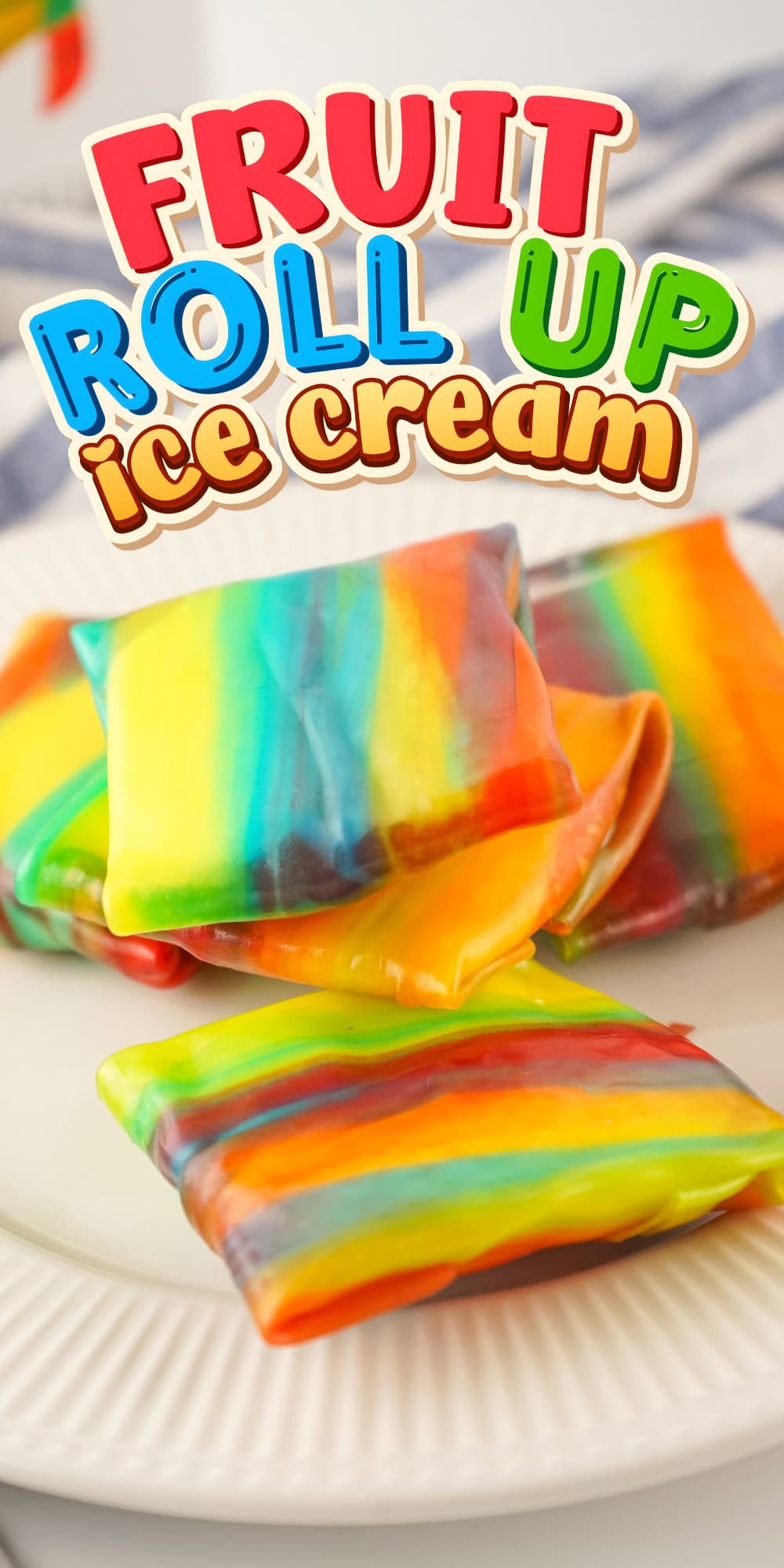 Colorful fruit roll-up ice cream squares stacked on a white plate.