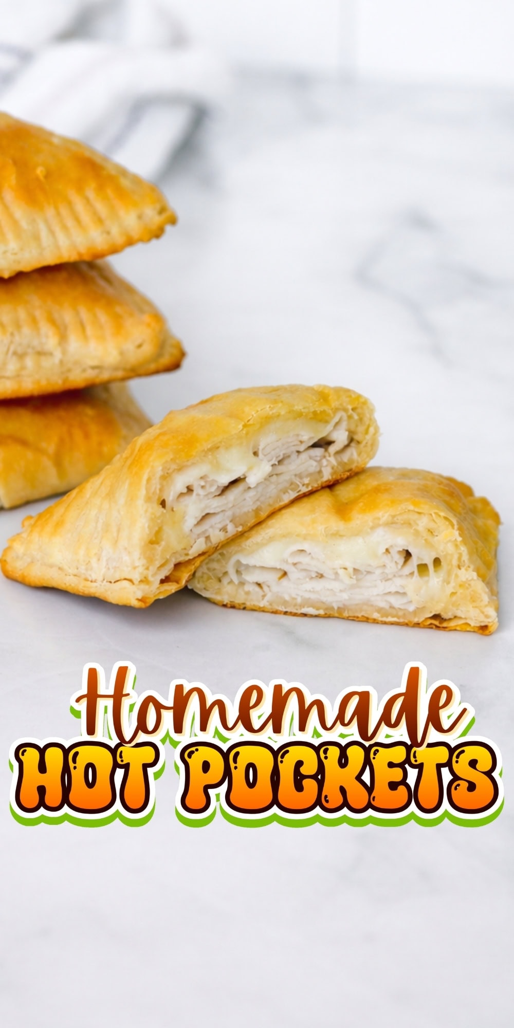 Golden homemade hot pockets stacked, one cut open to show chicken filling.