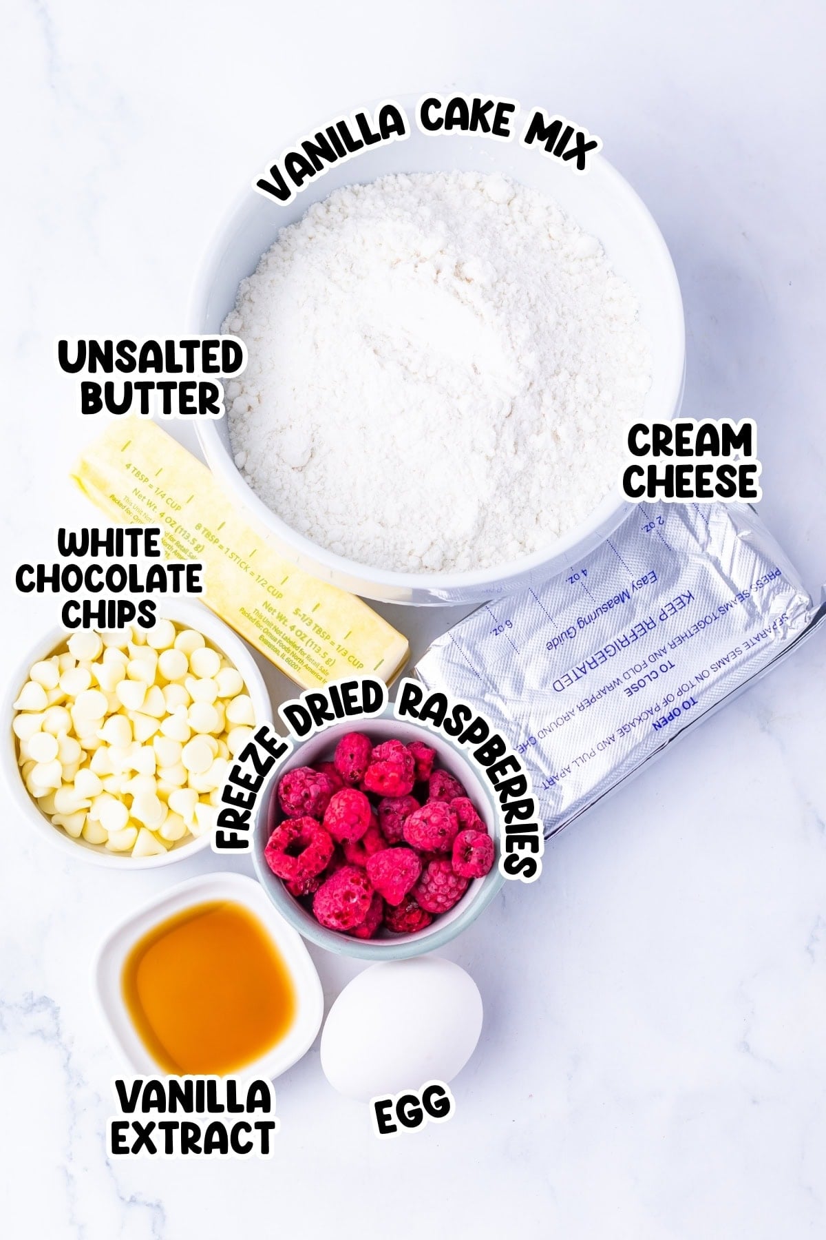 Bowl of cake mix, butter, cream cheese, white chips, raspberries, egg, vanilla.