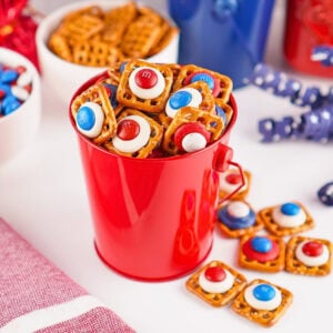 Red bucket filled with pretzel bites topped with red, white, and blue candies.