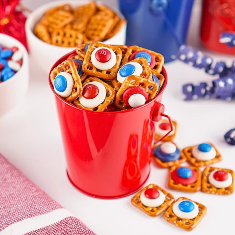 Red bucket filled with pretzel bites topped with red, white, and blue candies.