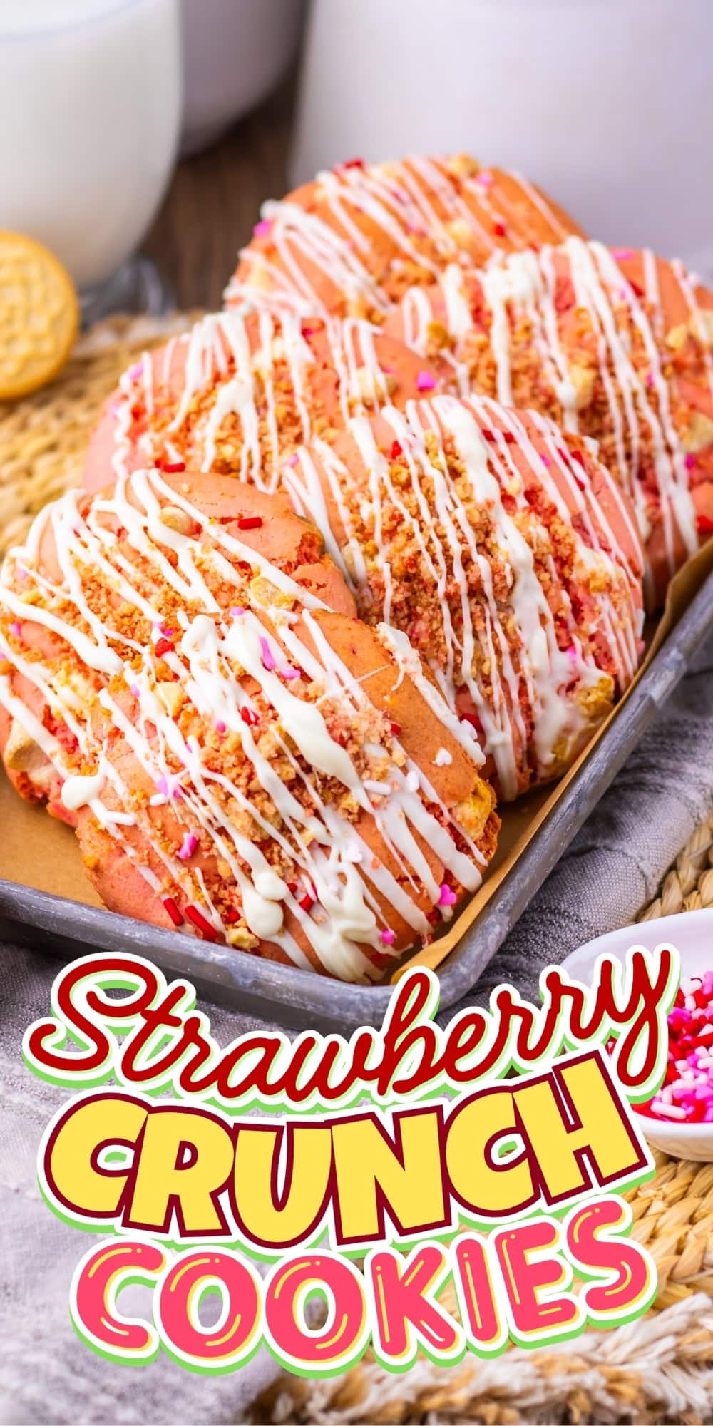 Several strawberry crunch cookies drizzled with white icing on a tray.