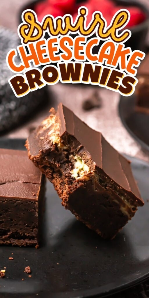 Two rich brownies with cheesecake swirls and chocolate topping on a black plate.