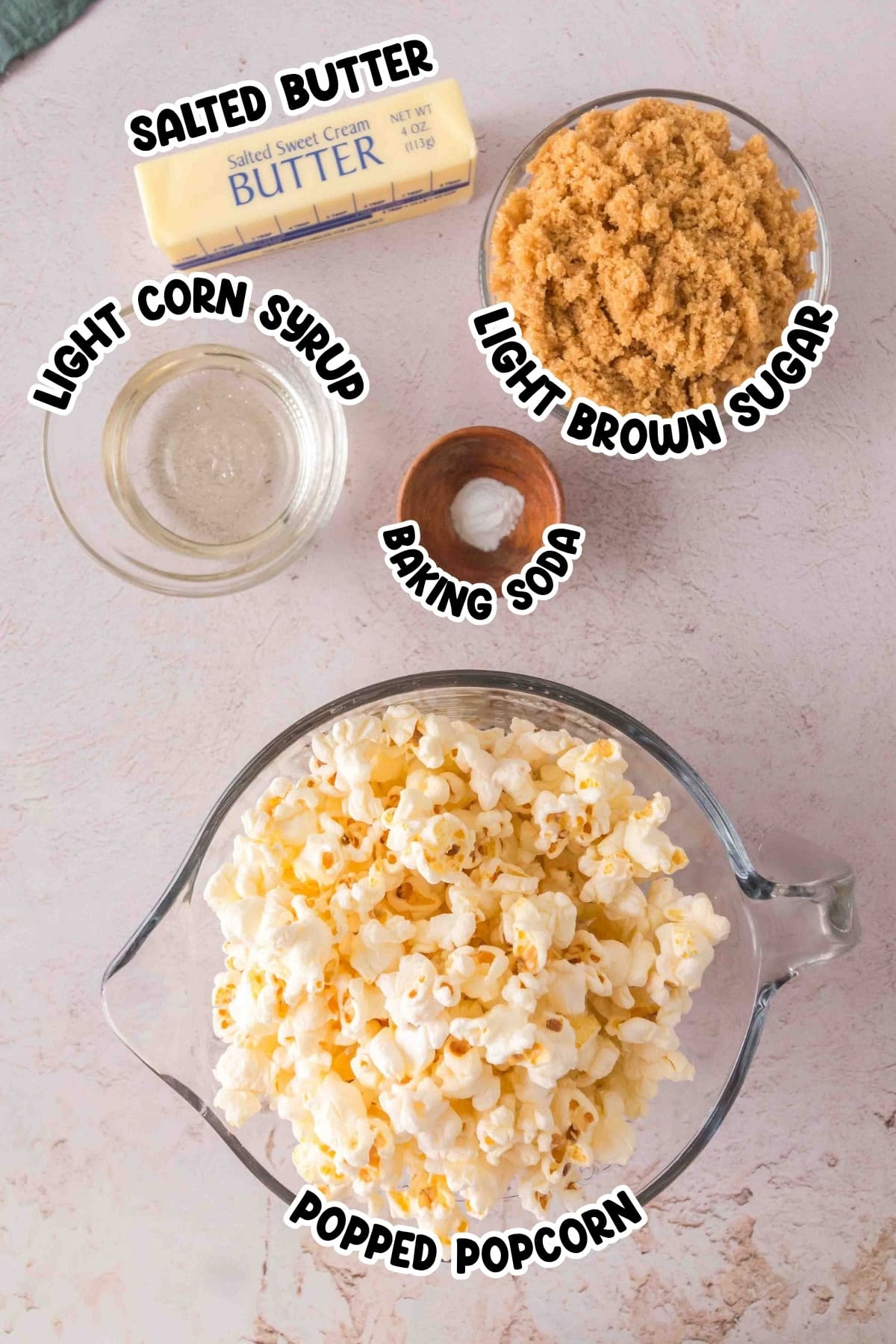 Ingredients for caramel popcorn: butter, brown sugar, corn syrup, baking soda, popcorn.