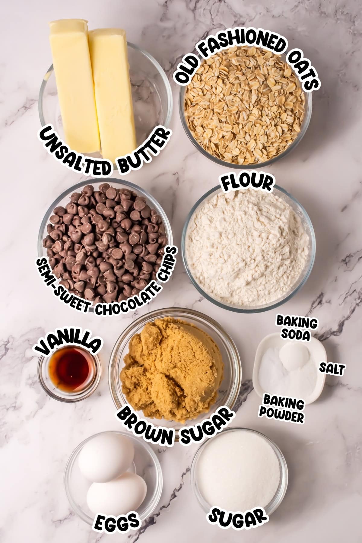 Baking ingredients in bowls: butter, oats, flour, chocolate chips, sugar, eggs, vanilla.