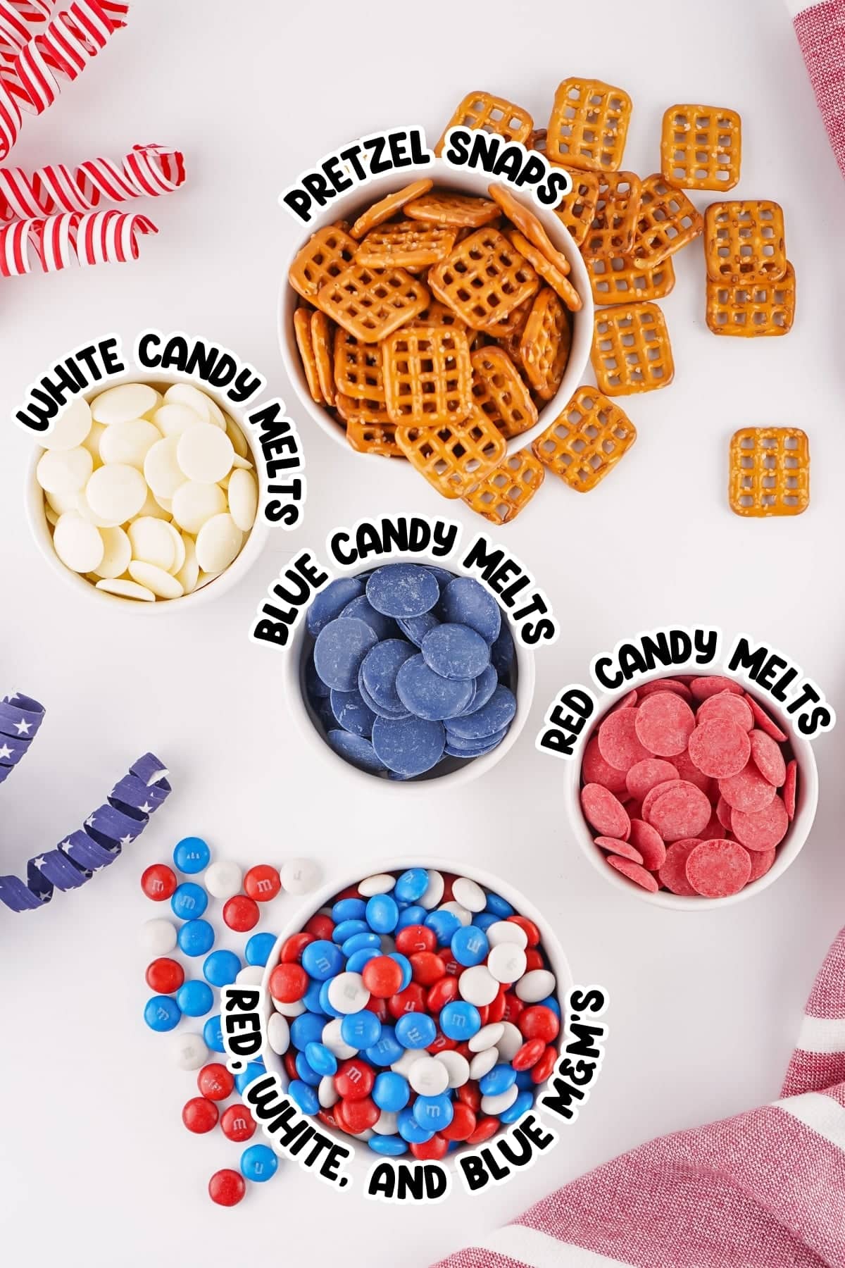 Bowls of pretzel snaps, colored candy melts, and red, white, and blue MM&rsquo;s.
