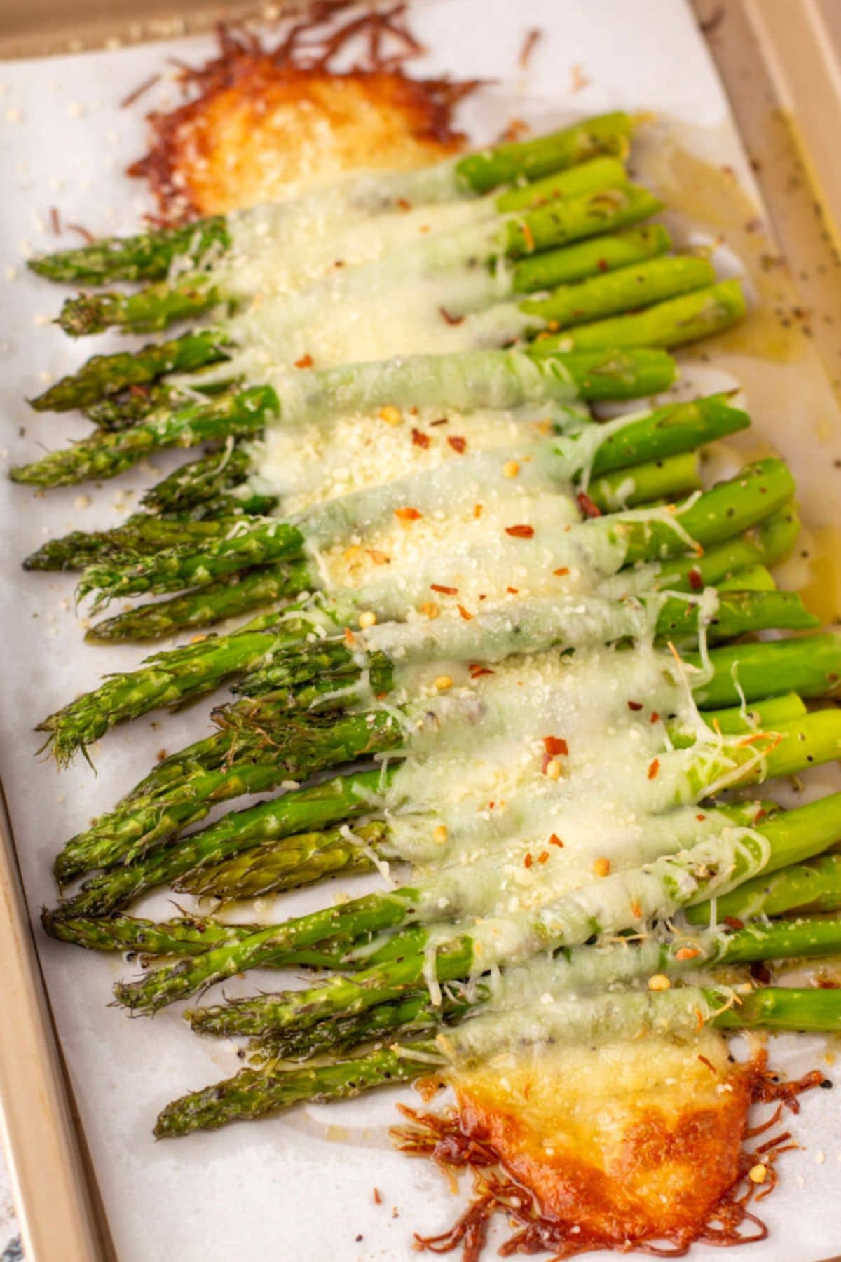 Roasted asparagus spears, a spring vegetable recipe, topped with cheese and spice.