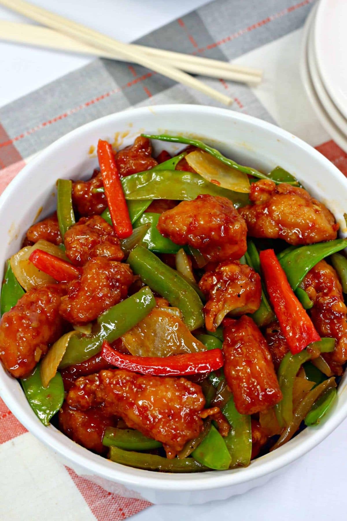 Bowl of stir-fried chicken with spring vegetable recipes and crisp snow peas.