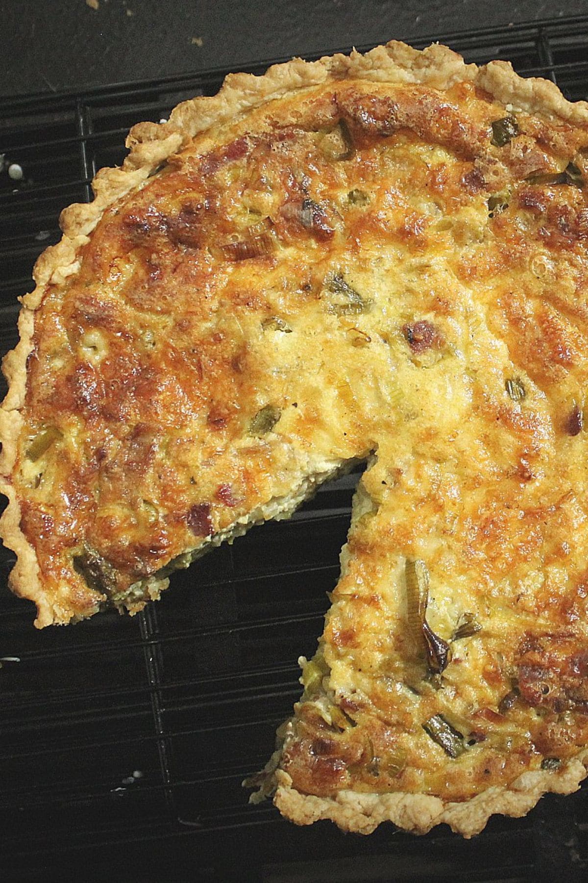 Baked quiche, perfect for spring vegetable recipes, on a cooling rack.
