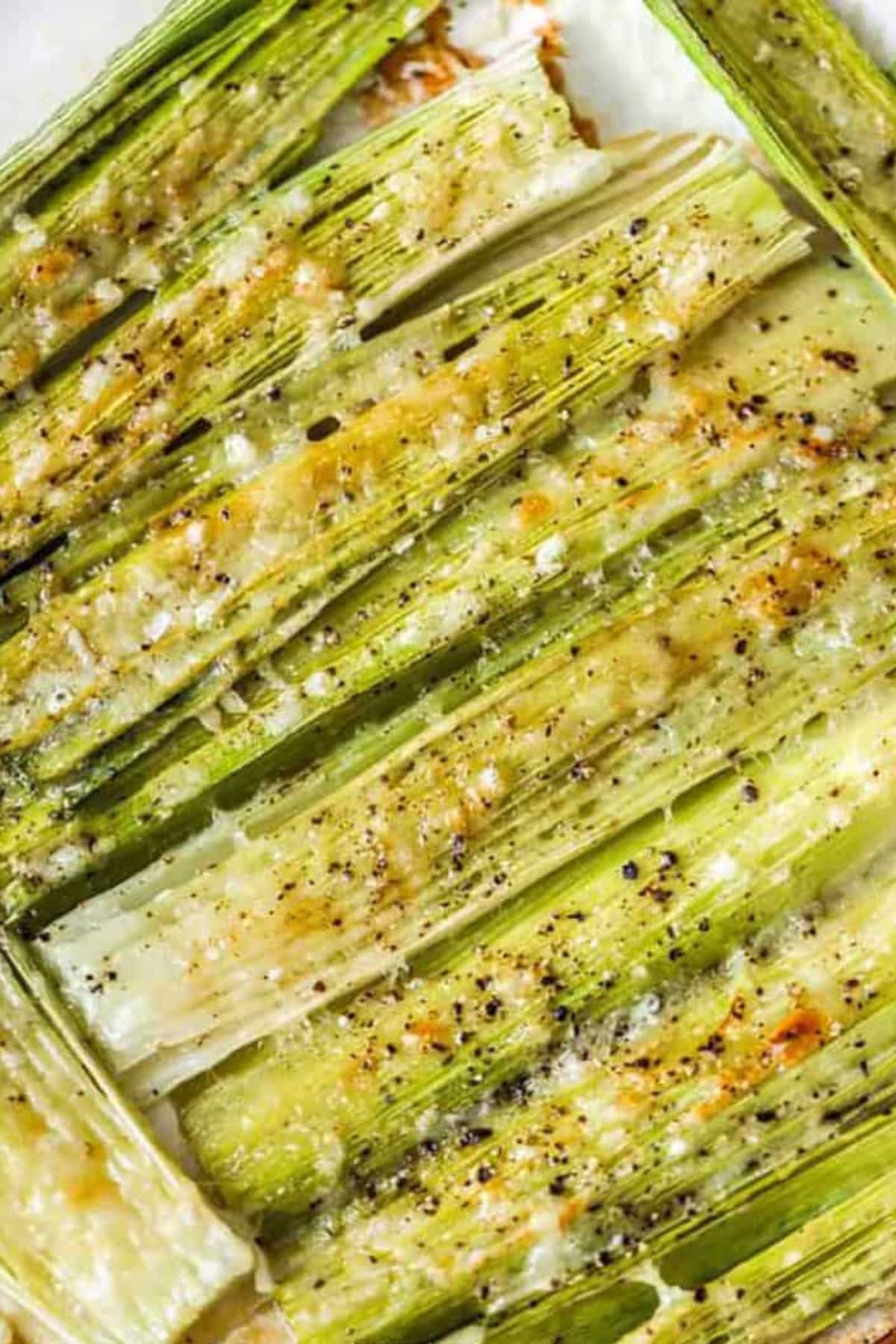 Close-up of roasted leeks with cheese, perfect for spring vegetable recipes.