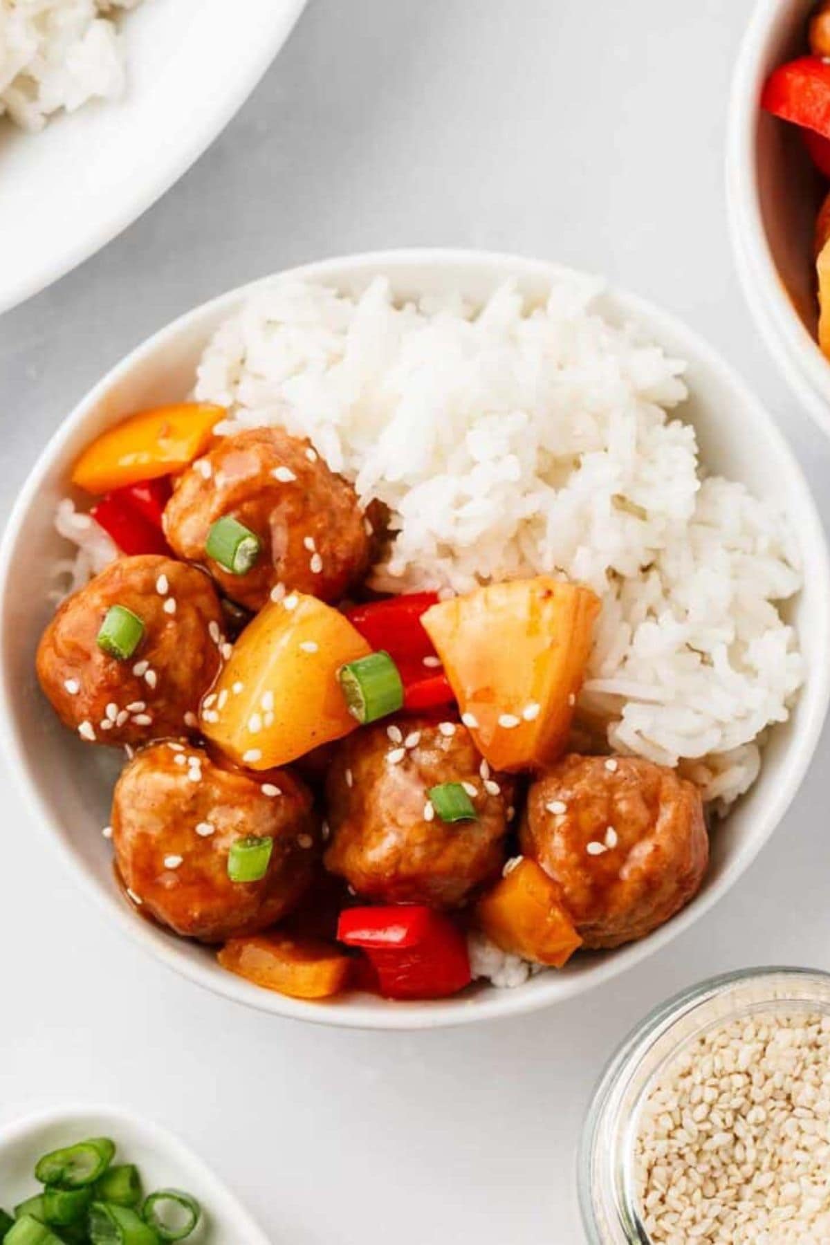 A spring crockpot recipe: rice with meatballs, bell peppers, pineapple, and sesame.