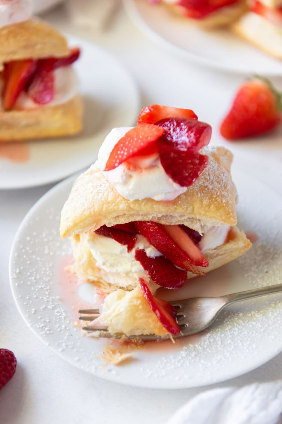 A strawberry shortcake pastry&mdash;perfect for easy strawberry recipes&mdash;on a plate.