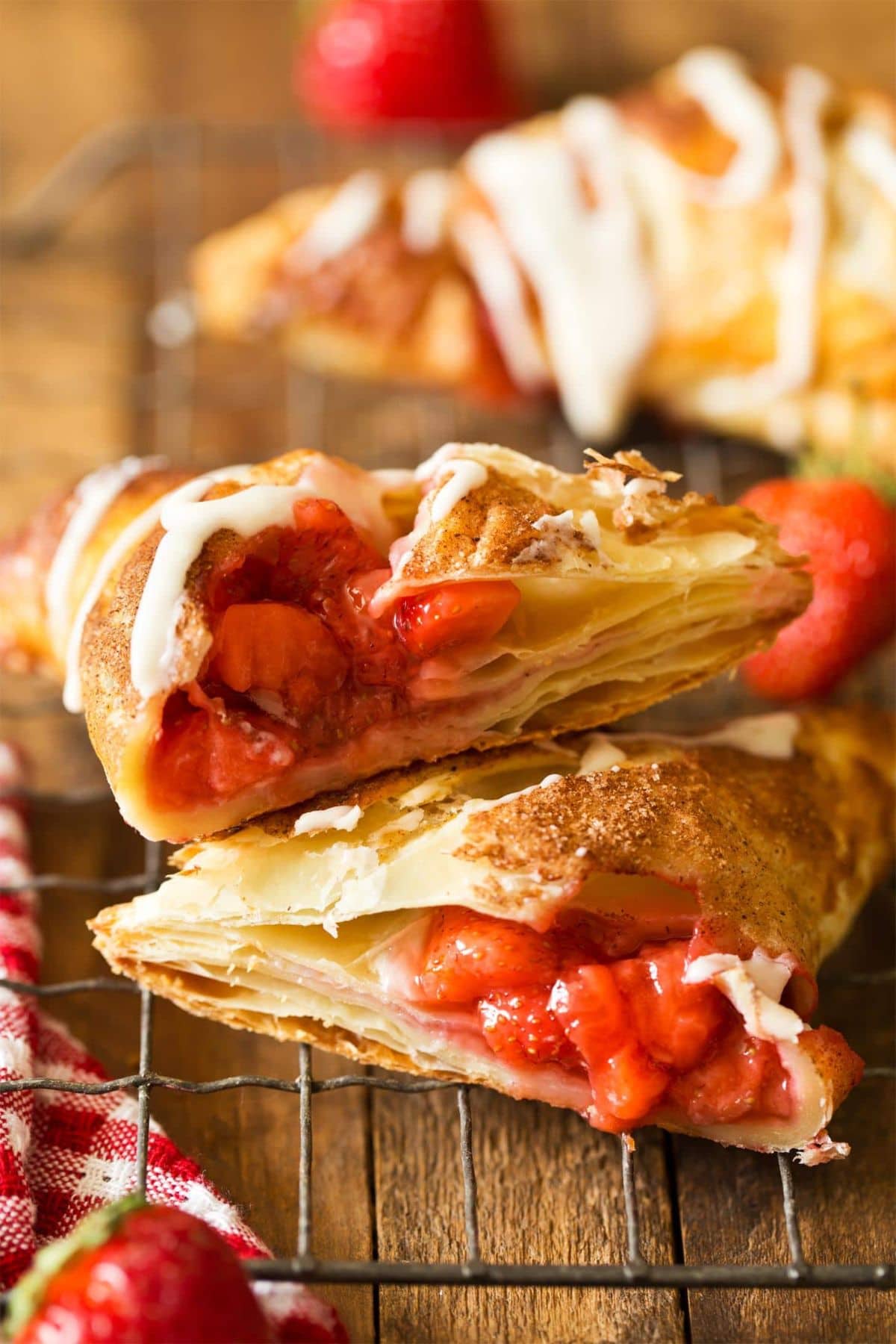 Easy strawberry recipes: turnovers with icing, one cut to show sweet filling.