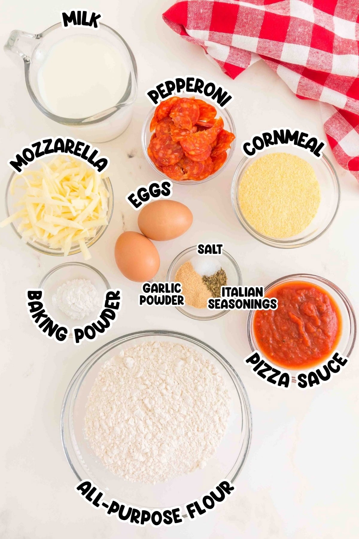 Pizza ingredients in bowls: milk, eggs, pepperoni, cheese, flour, sauce, and seasonings.