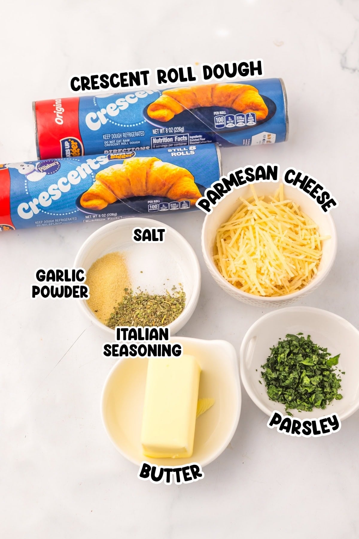Ingredients for cheesy crescent rolls: dough, cheese, butter, parsley, seasonings.