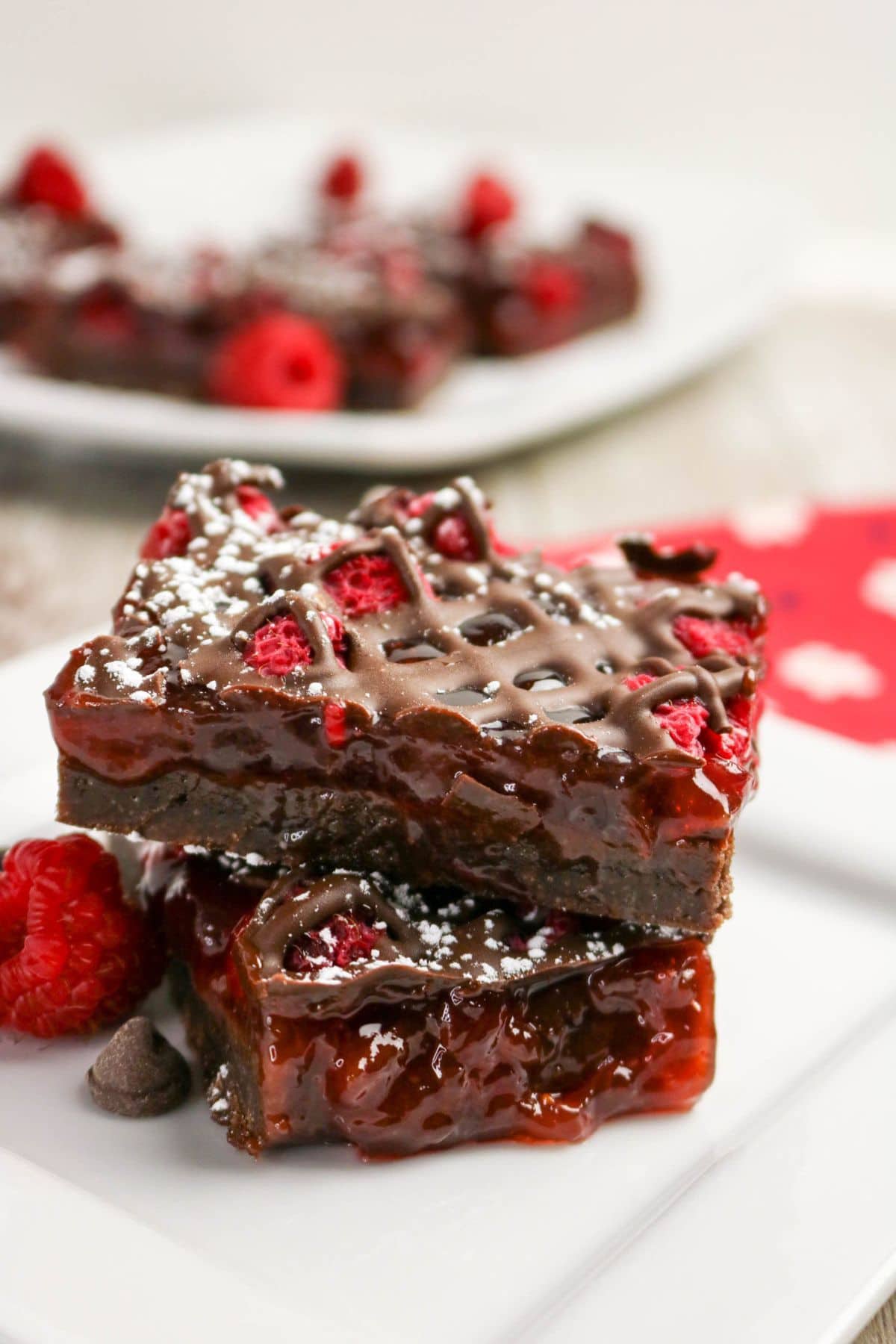 Two chocolate raspberry bars stacked, a delicious treat for raspberry recipes lovers.