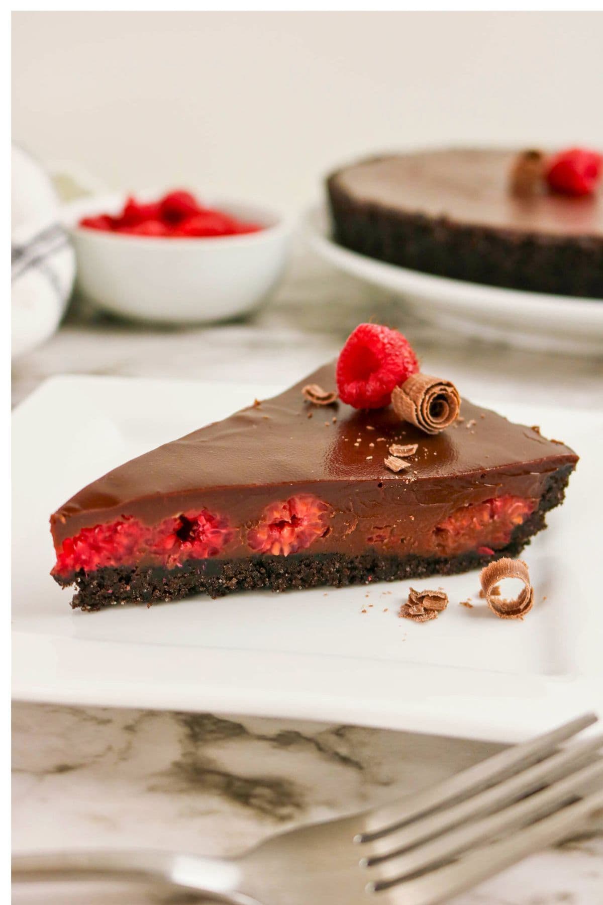 A slice of chocolate raspberry tart, perfect for fans of raspberry recipes.