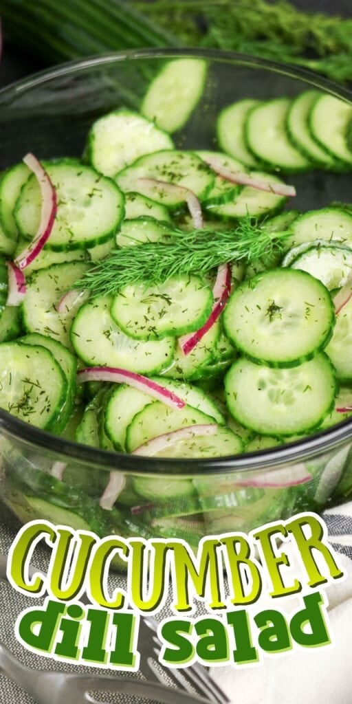 A bowl of cucumber dill salad with red onions and fresh dill garnish.