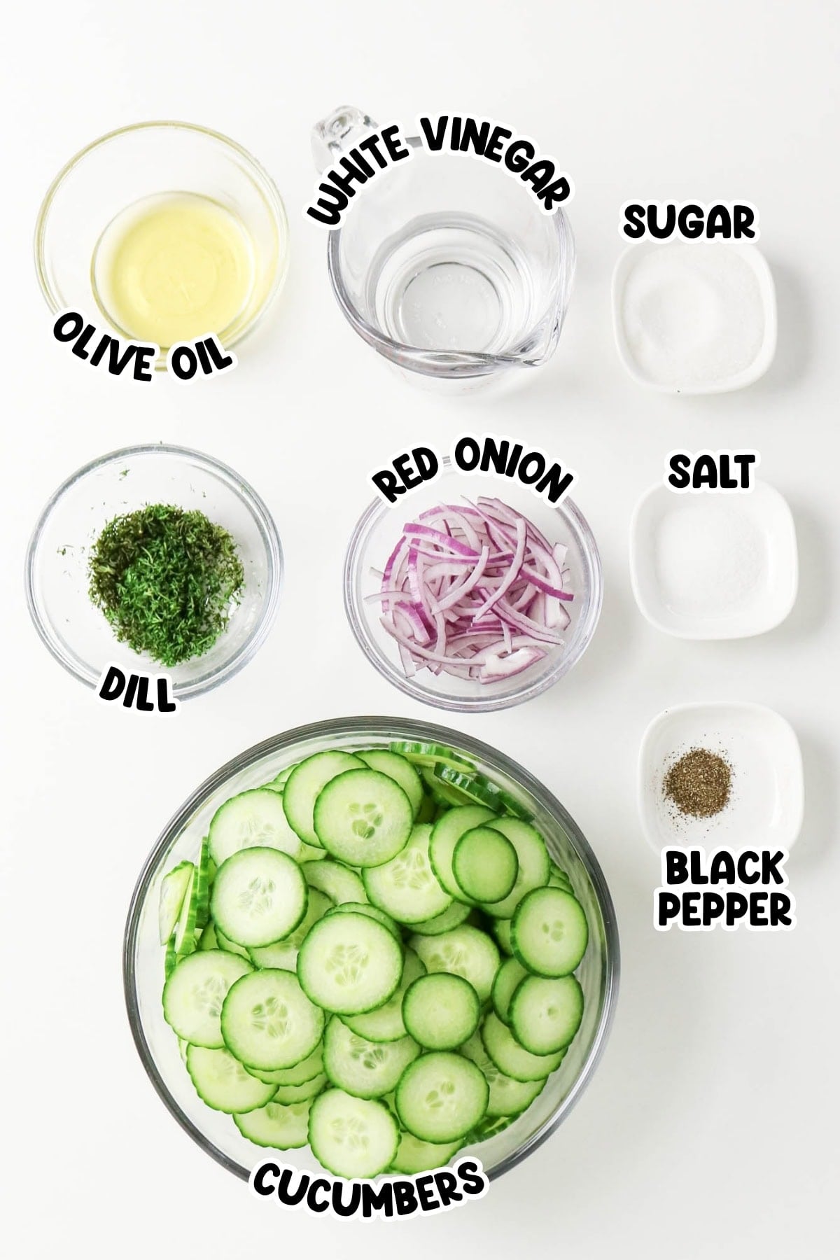 Bowls of sliced cucumbers, red onion, dill, olive oil, vinegar, sugar, salt, pepper.