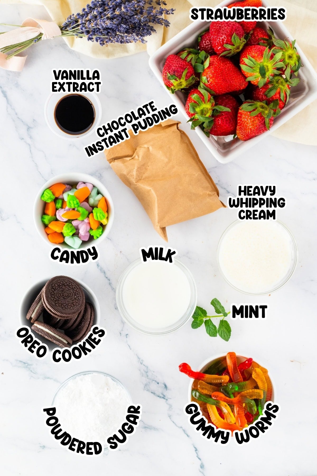 Ingredients for a dessert, including strawberries, candy, cookies, milk, and cream.