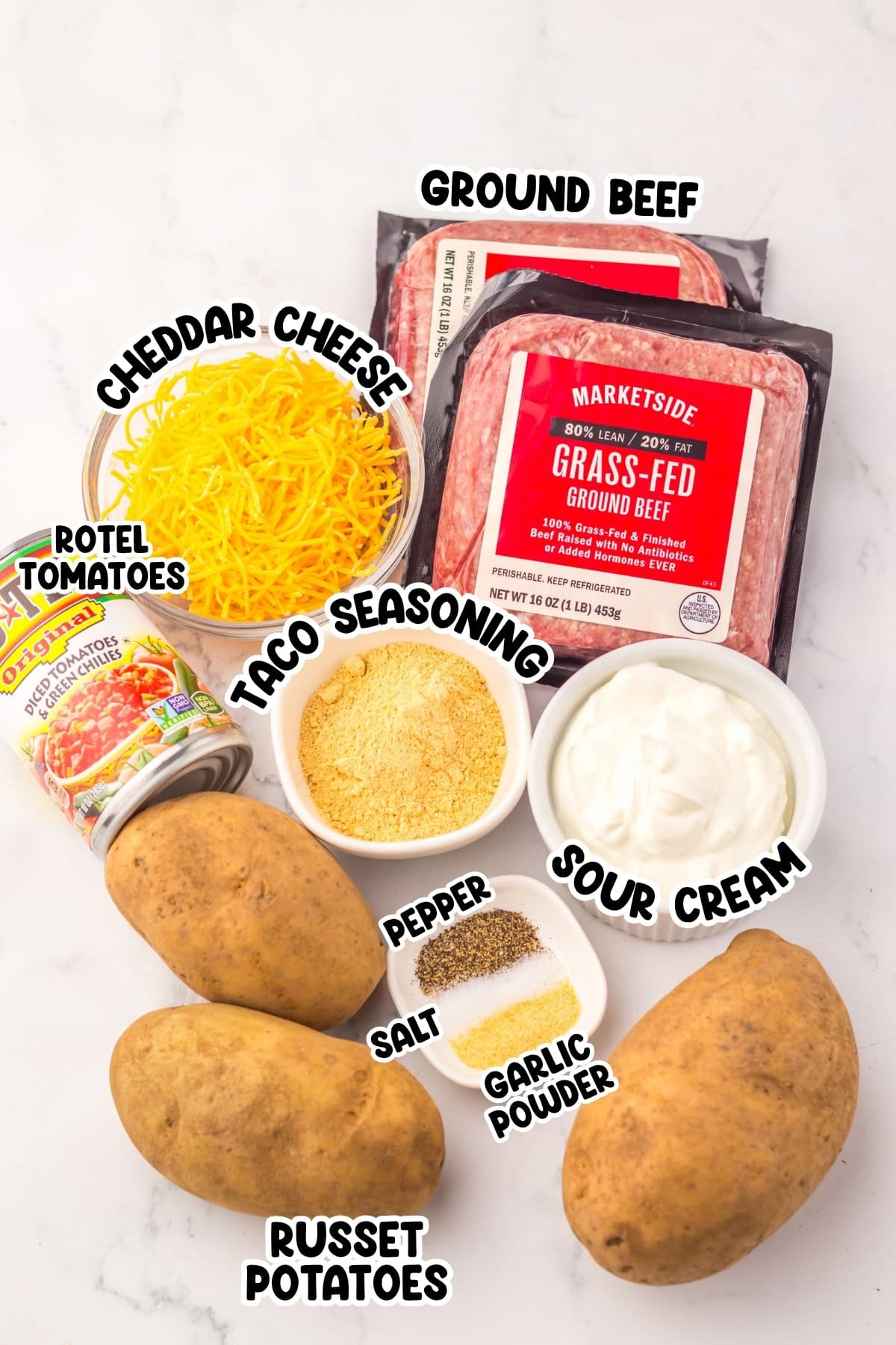 Ingredients for a taco potato dish, including ground beef, cheese, and seasonings.