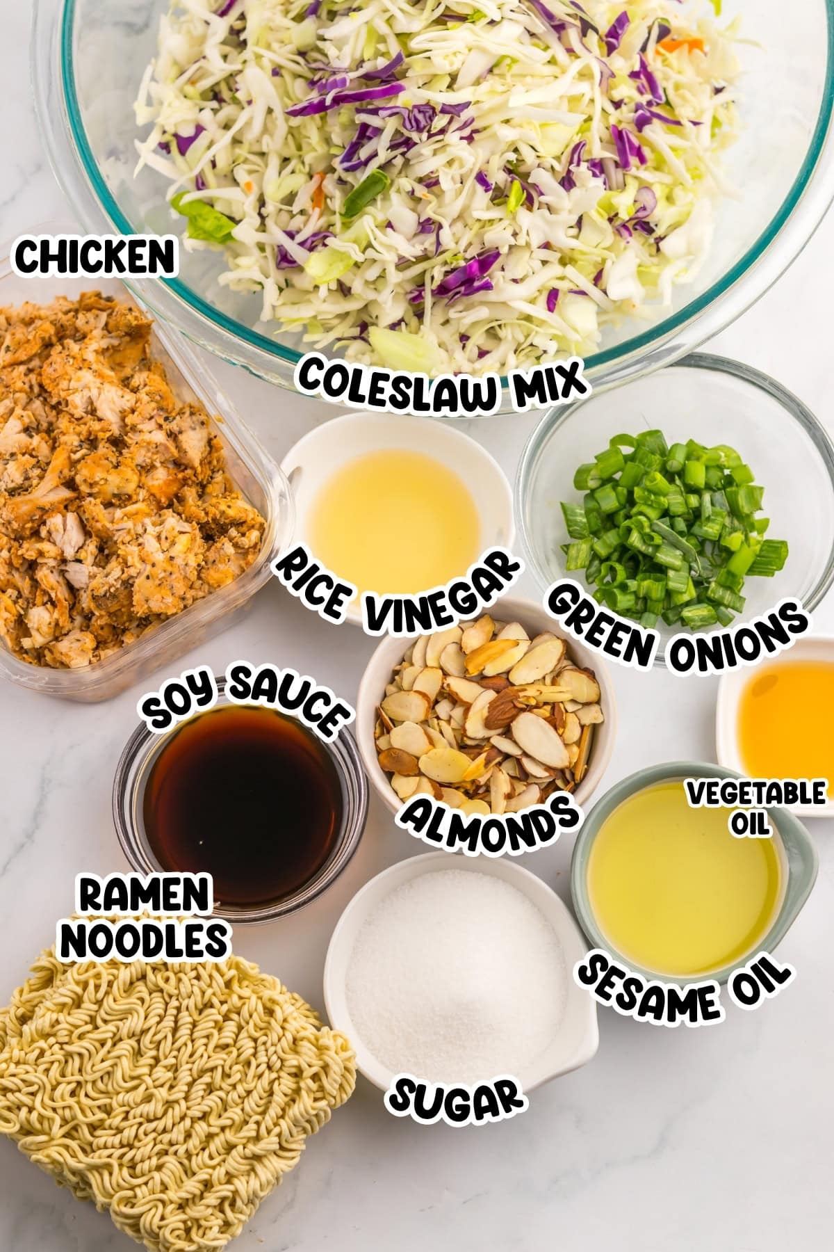 Ingredients for ramen noodle salad: chicken, coleslaw mix, almonds, soy sauce.