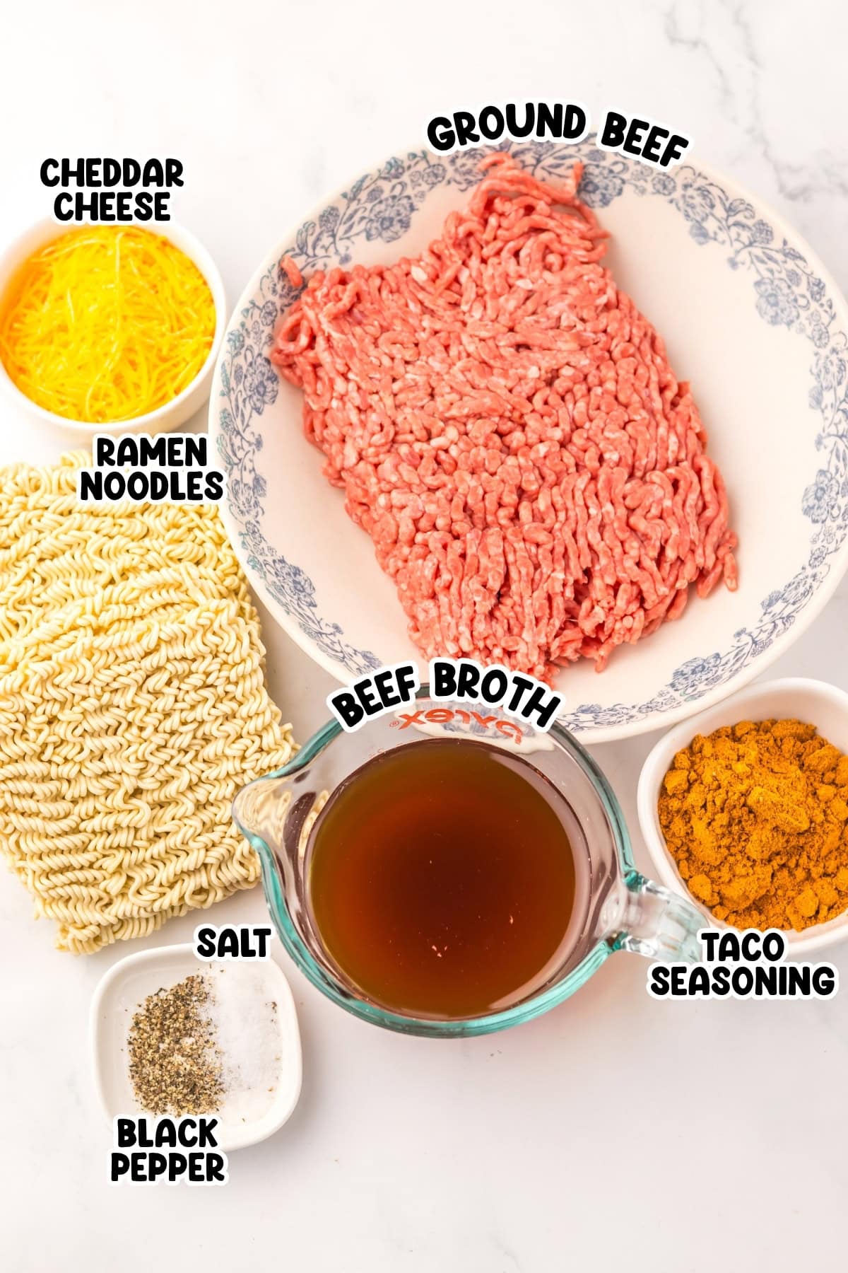 Ingredients for taco ramen: ground beef, ramen noodles, cheese, broth, seasonings.
