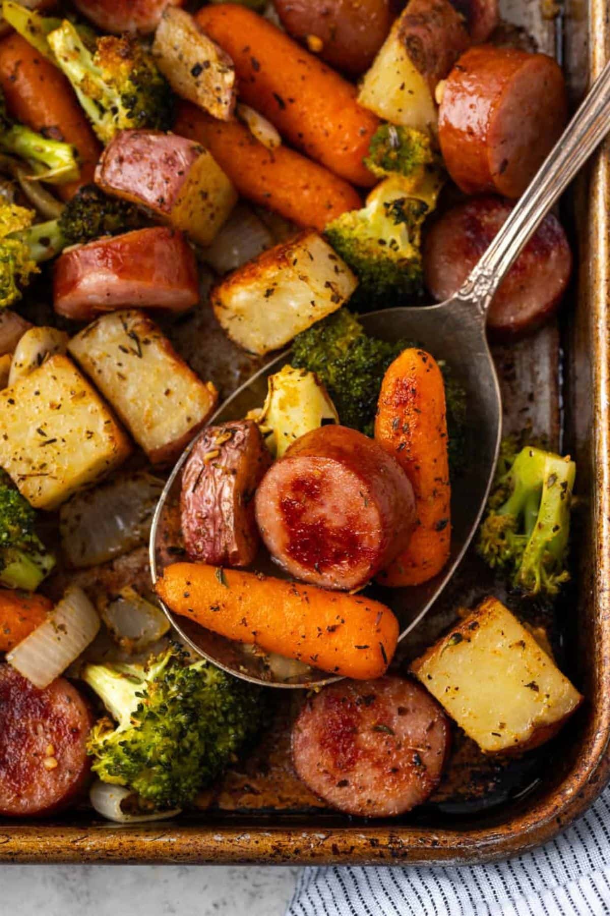 Kielbasa sausage meals with potatoes, carrots, and broccoli roasted with herbs.