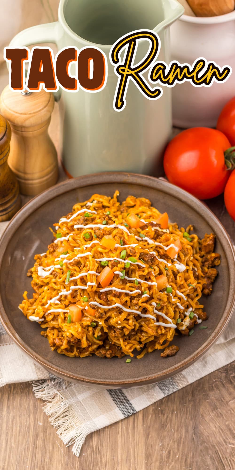 A plate of taco ramen topped with diced tomatoes, sauce, and green onions.