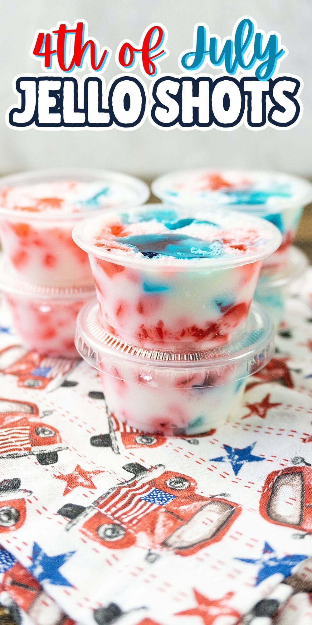 Three red, white, and blue Jello shots stacked on a patriotic-themed napkin.