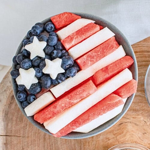 A bowl of fruit arranged to look like the American flag with stars and stripes.
