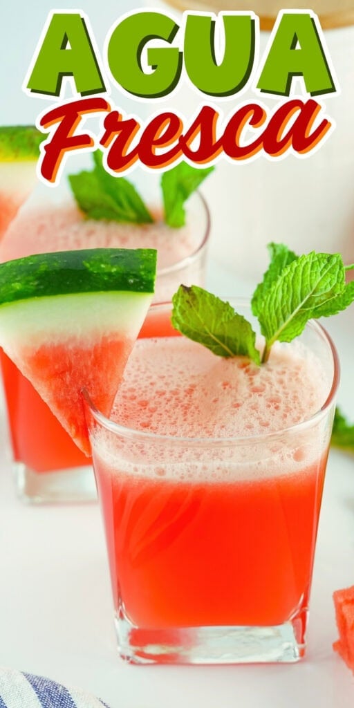 Watermelon agua fresca in a glass with mint and a watermelon slice garnish.