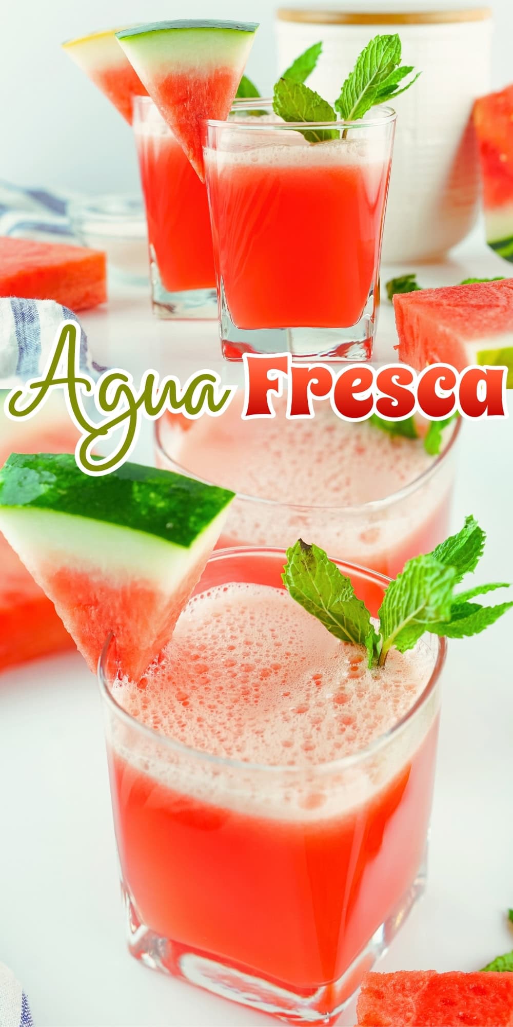 Glasses of watermelon agua fresca garnished with mint and watermelon slices.