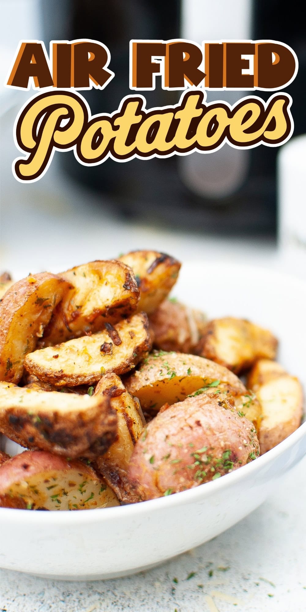 A bowl of crispy air fried potato wedges with herbs, text reads Air Fried Potatoes.
