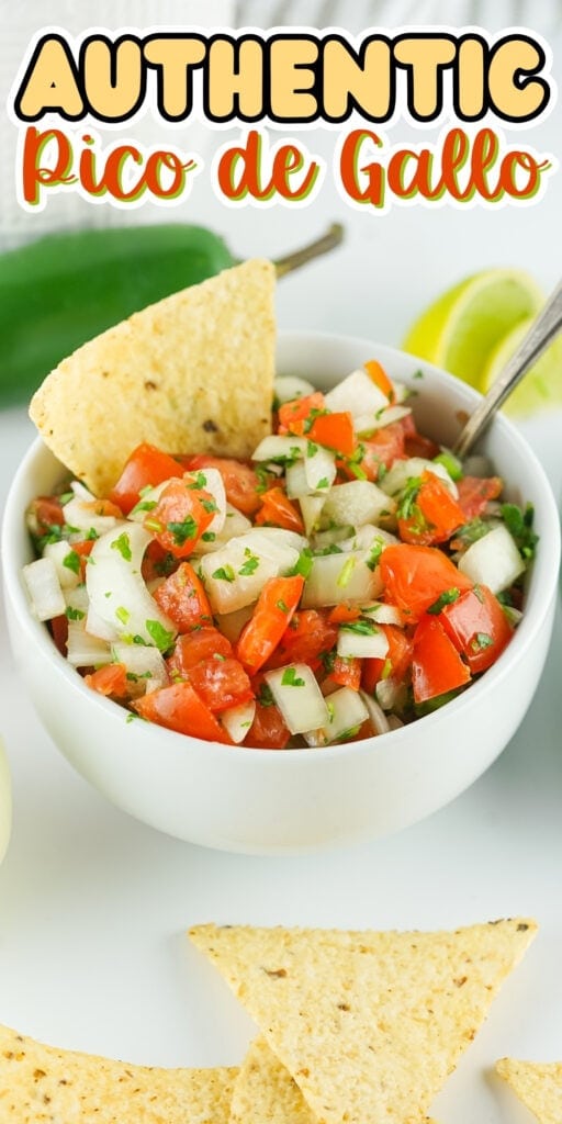 Bowl of pico de gallo with tortilla chips, lime, and jalapeño in the background.