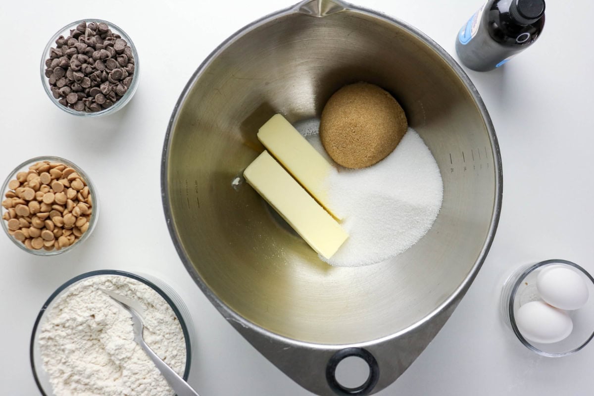 Baking ingredients: butter, sugar, eggs, flour, chips, and vanilla in bowls.
