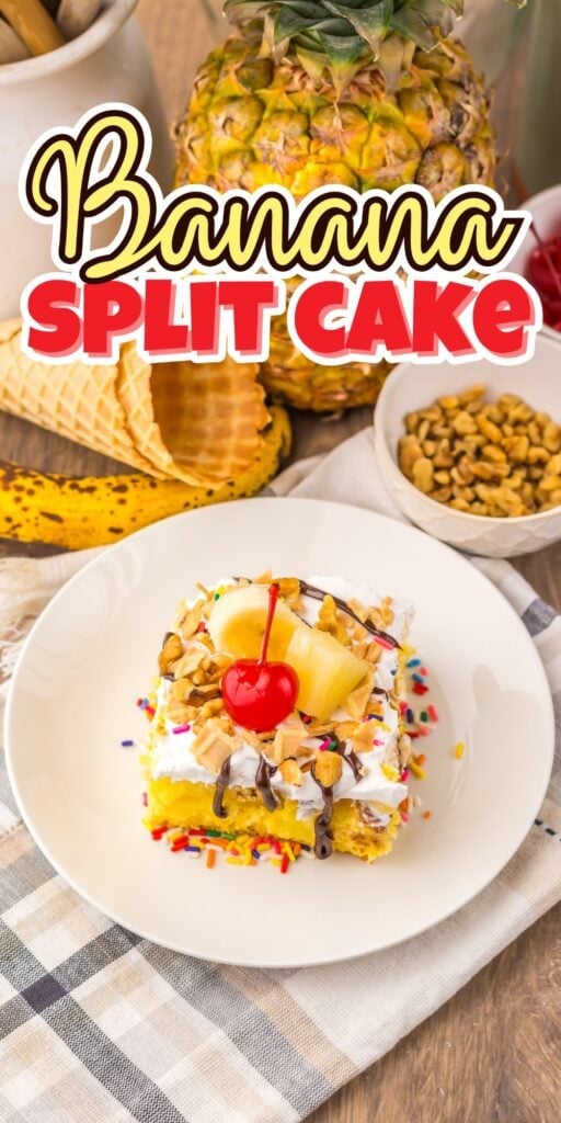 A slice of banana split cake with toppings and a cherry on a white plate.