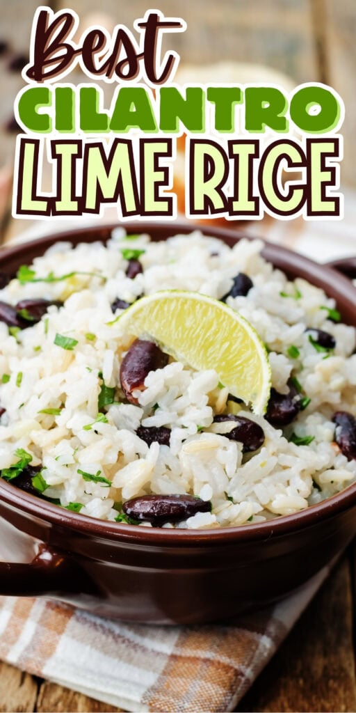 Bowl of cilantro lime rice with black beans, lime wedge, and chopped herbs.