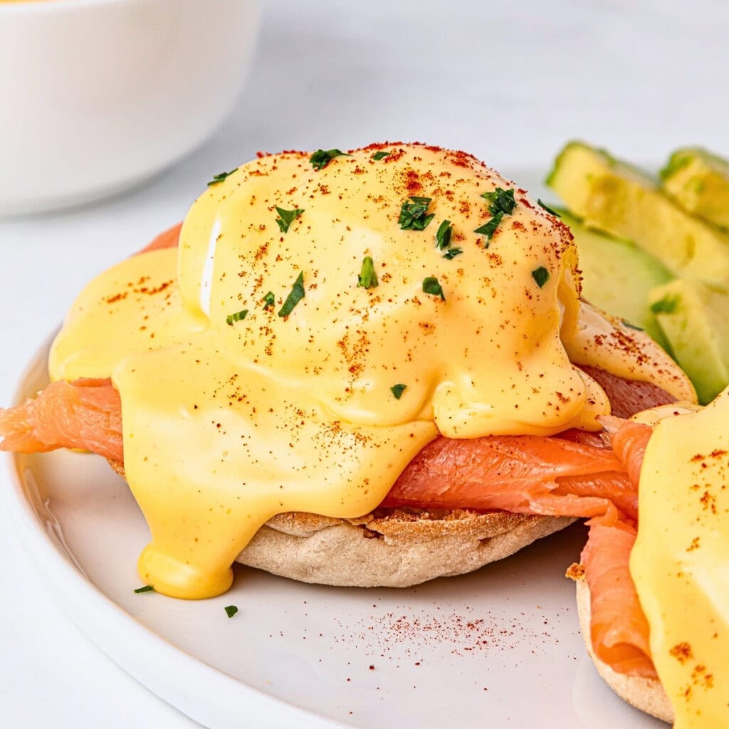 Eggs Benedict with smoked salmon and hollandaise sauce on an English muffin.