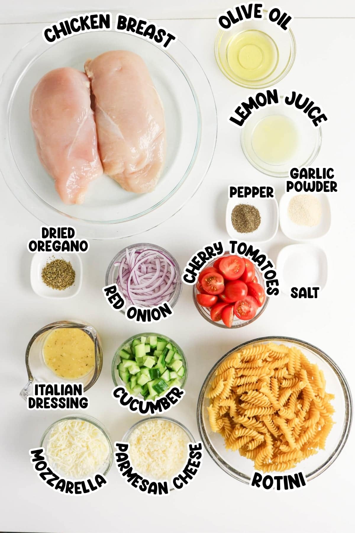 Ingredients for pasta salad, including chicken, pasta, cheese, veggies, and seasonings.