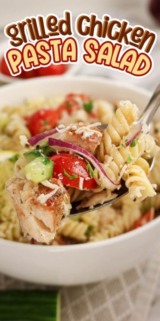 A fork holds grilled chicken pasta salad above a bowl, topped with veggies and cheese.