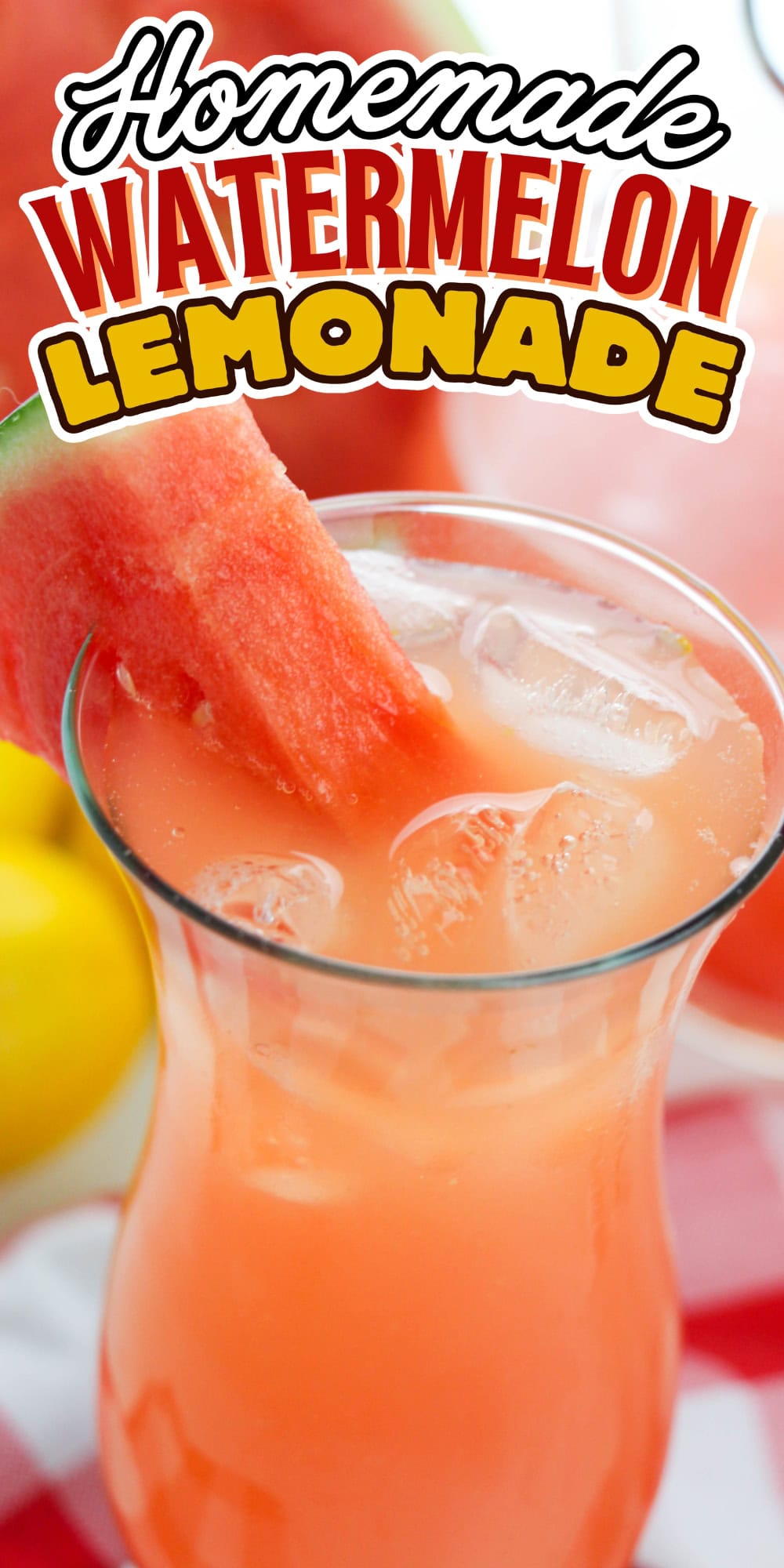 A glass of watermelon lemonade with ice and a watermelon slice garnish.